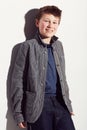 Teenager, fashion and portrait of boy in studio, white background and happiness. Cool, style and child with a smile Royalty Free Stock Photo