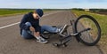 Teenager fell off bicycle. Boy keeps self for bruised knee Royalty Free Stock Photo