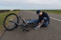 Teenager fell off bicycle. Boy keeps self for bruised knee Royalty Free Stock Photo