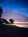 teenager with a fishing rod fishing on the river bank in nature Royalty Free Stock Photo