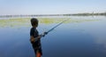 A teenager on a fishing trip keeps a close eye on the nibble. Sport fishing on the river in summer Royalty Free Stock Photo