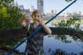 A teenager on a fishing trip shows off his catch - one small fish. Sport fishing on the river in summer Royalty Free Stock Photo