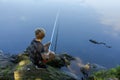 A teenager on a fishing trip waiting for a nibble of fish. Sport fishing on the river in summer Royalty Free Stock Photo