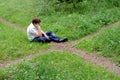 Teenager in forest by crossroad choose the path