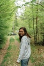 teenager gen z girl walking in the forest. close to nature concept Royalty Free Stock Photo