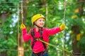 Teenager girl adventure and travel. Beautiful Little girl climbing and having fun in adventure Park. Happy little girl