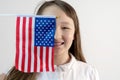 Teenager girl with american flag in hand on a white background. The concept of education in the United States Royalty Free Stock Photo