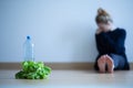 Girl with anorexia nervosa being on restricted diet of water and salad