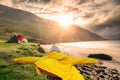 Teenager girl back to camera. Hands up in the air, Her jacket if lifted by a strong wind. Beautiful nature scene with ocean and