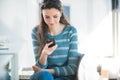 Teenager girl at the bar texting with her mobile Royalty Free Stock Photo