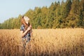 Teenager girl in a field full of yellow ears Royalty Free Stock Photo