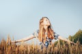 Teenager girl in a field full of yellow ears Royalty Free Stock Photo