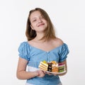 Teenager girl in blue dress holds plate of cream sweet cakes and smiles, Studio portrait on white background