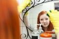 Teenager girl cleans mirror Royalty Free Stock Photo
