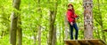 Teenager girl climbing in high rope course or parl