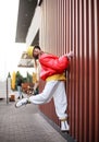 Teenager girl in colorful youth urban style clothes on city street