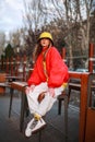 Teenager girl in colorful youth urban style clothes on city street