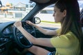 Teenager girl concentrating while driving car