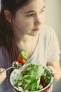 Teenager girl with cut cucumber tomato salad bowl Royalty Free Stock Photo