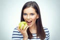 Teenager girl with dental braces bites apple.