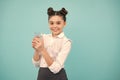 Teenager girl drinking water from glass on blue background. Daily life health. Drink water for health care and body Royalty Free Stock Photo