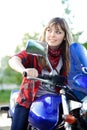 Teenager girl drive blue motorcycle Royalty Free Stock Photo