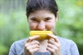 Teenager girl eating boiled corn cob close up photo Royalty Free Stock Photo