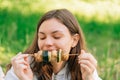 Teenager girl eating grilled vegetables outdoors. Vegan picnic with mushrooms and zucchini