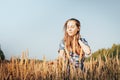 Teenager girl in a field full of yellow ears Royalty Free Stock Photo