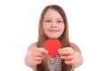A teenager girl gives a heart made of paper