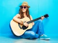 Teenager girl guitar play sitting on a floor. Royalty Free Stock Photo