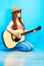 Teenager girl guitar play sitting on a floor. Royalty Free Stock Photo