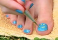 Teenager girl hand with enamel laque brush pedicure her toes foot Royalty Free Stock Photo