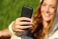 Teenager girl hand using a smart phone with her face in the background Royalty Free Stock Photo