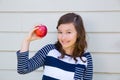 Teenager girl happy eating an apple