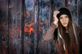 Teenager girl hipster on rusty fence background.