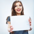 Teenager girl hold white blank paper. Young smiling woman show Royalty Free Stock Photo