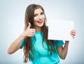 Teenager girl hold white blank paper. Young smiling woman show Royalty Free Stock Photo