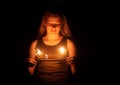 Teenager girl holding a burning sparklers in her hands. Royalty Free Stock Photo