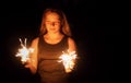 Teenager girl holding a burning sparklers in her hands. Royalty Free Stock Photo