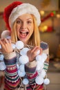 Teenager girl holding tangled christmas lights