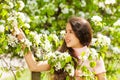 Teenager girl holding white flowers on pear tree Royalty Free Stock Photo