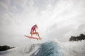 Teenager girl jumping on the orange wakeboard Royalty Free Stock Photo