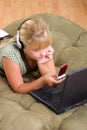 Teenager girl with laptop and cell phone