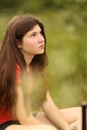 Teenager girl with long thick brown hair outdoor portrait
