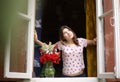 Teenager girl look out of the window at morning f Royalty Free Stock Photo
