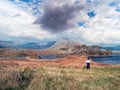 Teenager girl looking at amazing view. Twelve pines island, county Galway, Ireland. Irish beautiful landscape. Travel concept.