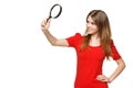 Teenager girl looking through the magnifying glass Royalty Free Stock Photo