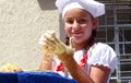 Teenager girl making dough during parade, Ecuador