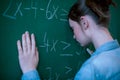Teenager girl in math class overwhelmed by the math formula. Pressure, Education, Success concept. Royalty Free Stock Photo